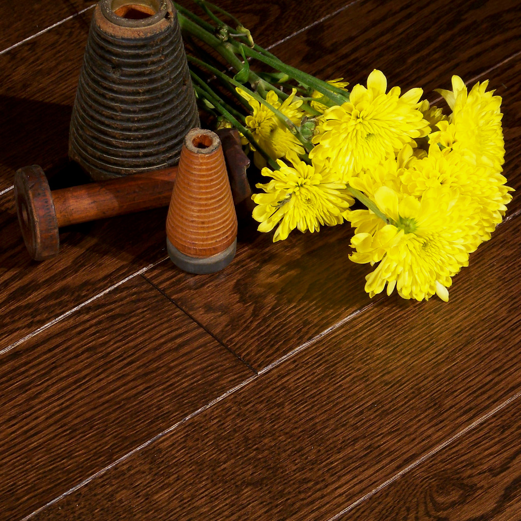 Woodhouse, Frontenac, Belcourt Wood Floor shown with yellow flowers and textile bobbins