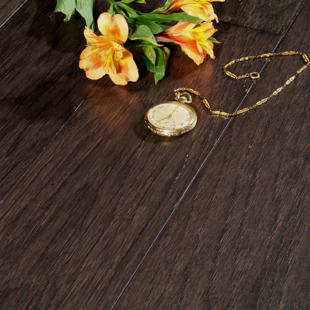 Close up picture of Woodhouse, Jamestown Wood Flooring with pocket watch and yellow flowers