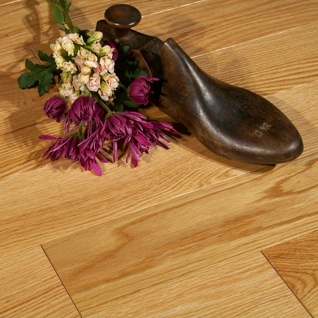 Woodhouse, Frontenac, Natural Red Oak Wood Floor shown with flowers and wooden show form