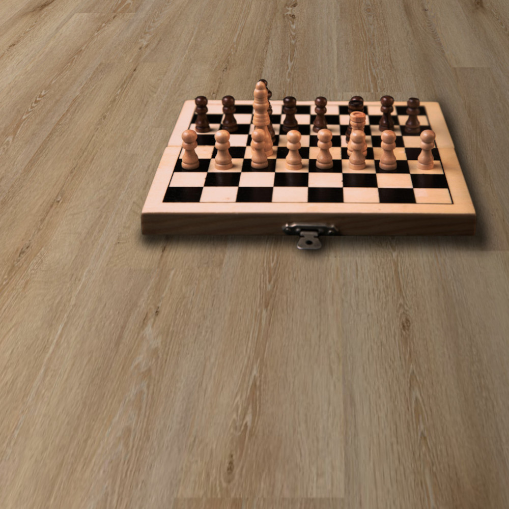 WoodHouse Pacific Winds Cut Creek laminate floor shown with a chess set